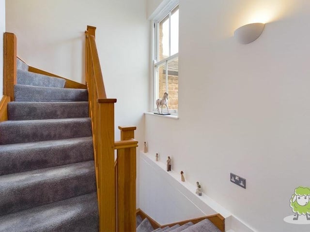 A look at the pleasant staircase, which links the three floors of the property.