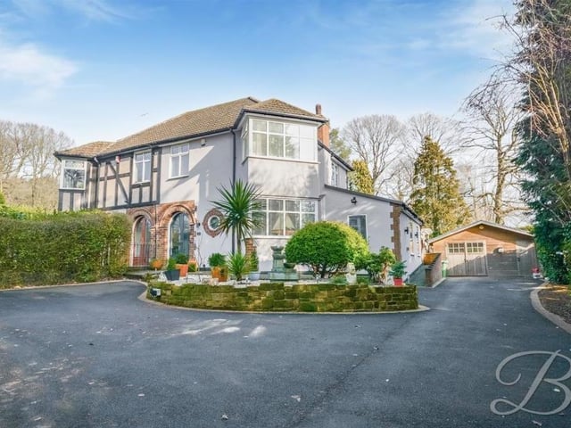 This photo underlines the large amount of off-street parking space there is on the tarmac driveway at the front of the property. The surrounding trees offer a good degree of privacy.