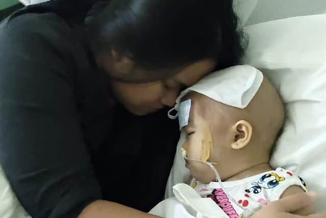 Baby Ryzy being cuddled by her mum in a Philippines hospital.