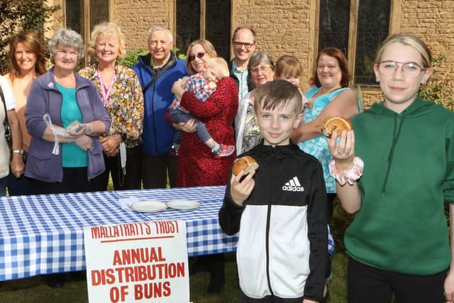 Tyler and Alicia Moss-Burton were among the youngsters given a hot cross bun at the open weekend, to maintain the tradition of Mary Mallatratt's Dole, first established in 1894.