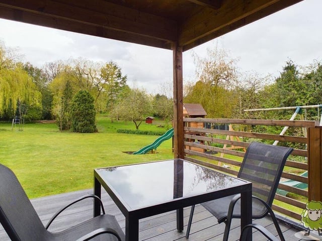 The summer house is a relaxing spot in the sizeable garden.
