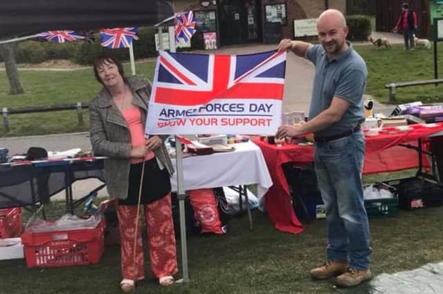 Eileen Massey, founder of Veterans Unite, and Coun Scott Carlton, fly the flag at Sunday's event for Armed Forces Day, which is to be held in June.