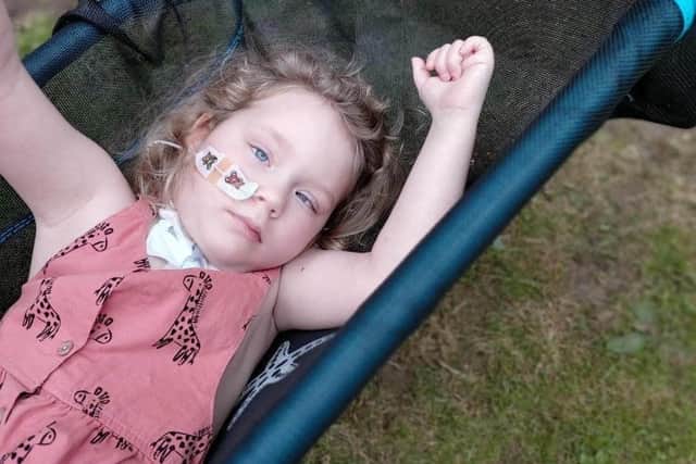 Five year old Chloe Askew on her special swing donated by Corah's Song charity.