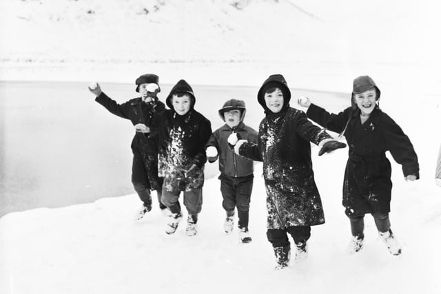 Children throwing snowballs at the photographer in Holyrood Park during their Christmas break in 1966.