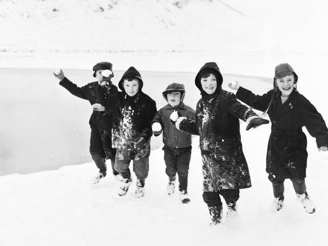 Children throwing snowballs at the photographer in Holyrood Park during their Christmas break in 1966.