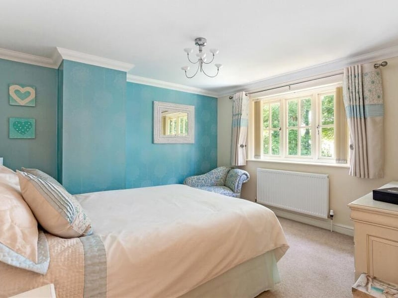 The principal bedroom, which overlooks the back garden, radiates comfort. It includes a built-in storage cupboard and has access to an en suite bathoom that features a fitted bath, quadrant shower cubicle, low-level WC, vanity wash hand basin and chrome heated towel-rail,