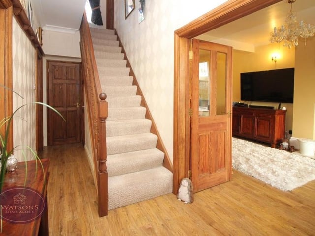 The entrance hall also includes the staircase that leads us to the first floor and three more of the property's bedrooms. There is storage space underneath the stairs.