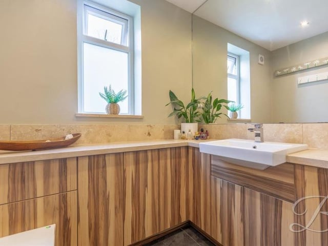 A second look at the three-piece suite in the shower room, which also features a vanity unit and low-flush WC.