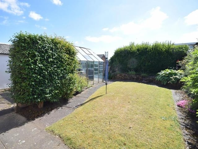 Another shot of the back garden, which offers a high level of privacy, with its hedges and shrubbery borders, plus a securely fenced, enclosed boundary.