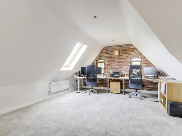 This versatile space has decorative exposed brick and offers flexible living options.