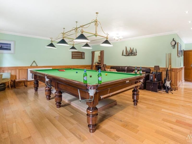 Next stop in the entertainment wing is the vast games room, which is dominated by this professional snooker table dating back to 1890. There is also a bar and access to the indoor swimming pool and the garden.