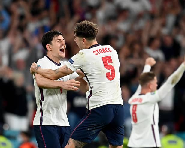 Harry Maguire and John Stones celebrate England's victory over Denmark at Euro 2020. (Photo by Andy Rain - Pool/Getty Images)