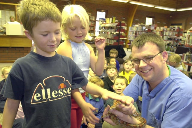 Demi Oxley and Kyle Thompson  of Mintini Primary school pictured with Springfield Vet William Taylor  and a snake at the Ecclesfield Library in 2001