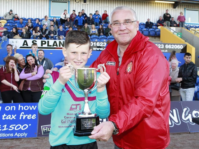 Chad Youth League Chairman Mick Kozluk presents Welbeck's George Smith-Grout the Knockout Trophy.