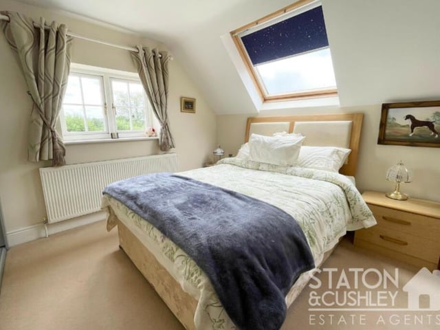Moving on now the cosy second upstairs bedroom, which boasts fitted wardrobes and access to an en suite shower room. The Velux window faces the front of the £650,000-plus house.