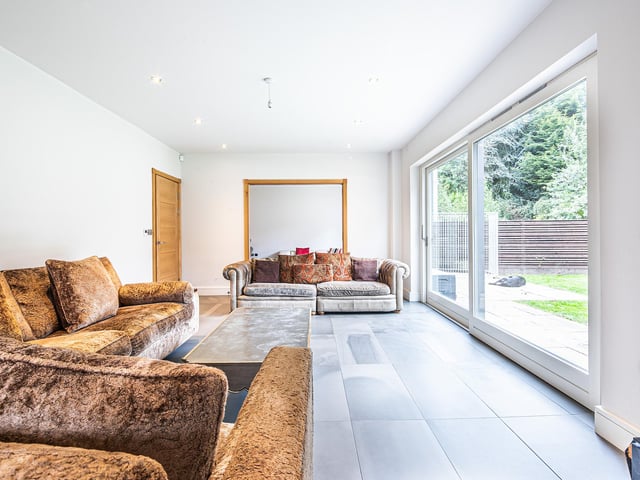 Natural light floods in through the lounge's glazed sliding doors.