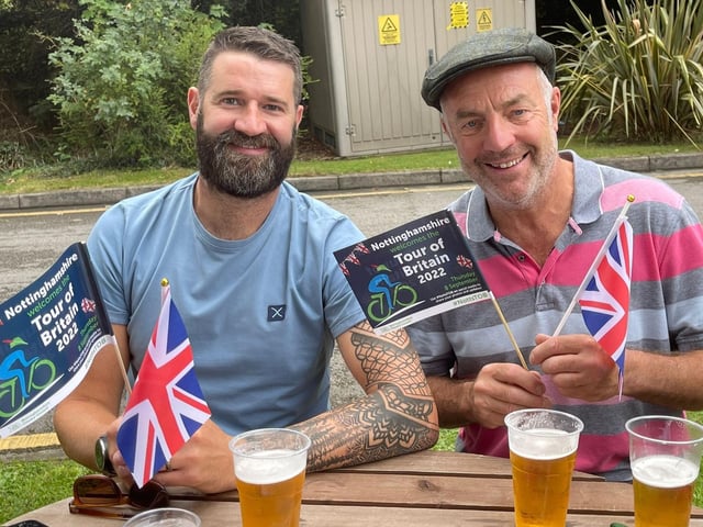 Having a pint and getting ready for riders to cycle past.