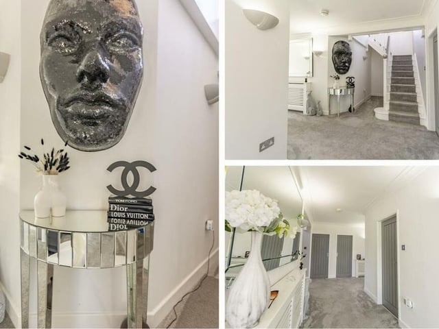 As we prepare to take a look at the first floor, let's pass through the entrance hall. It has a carpeted floor, stylish wall-lights and staircase.