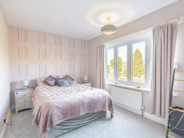 The third bedroom on the first floor has a touch of glamour about it. Overlooking the front of the house, it boasts fitted wardrobes and a carpeted floor.