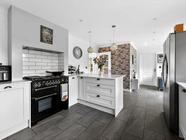 The impressive and sociable kitchen opens into a sitting area, creating a fantastic hub for everyday family life.