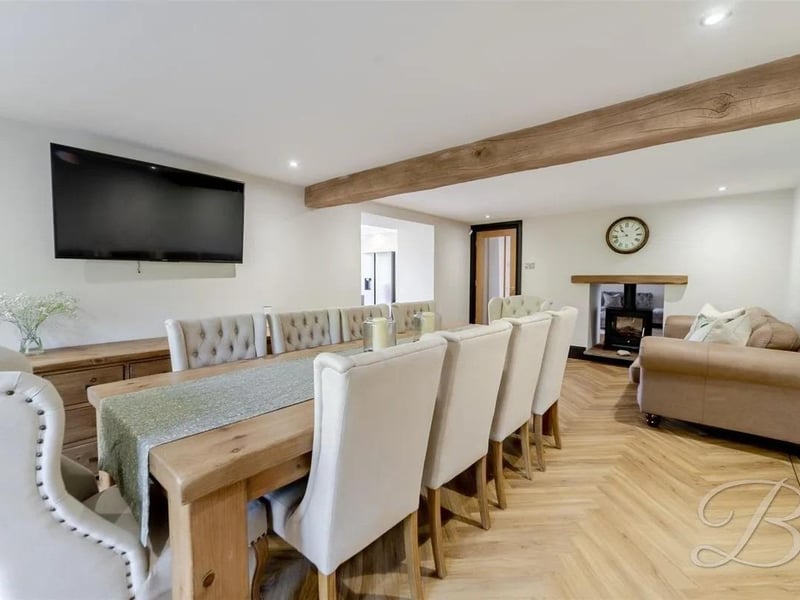 The dining/living space flows seamlessly through to the kitchen, making it ideal for modern living and entertaining, while side windows allow natural light to brighten the room throughout the day.