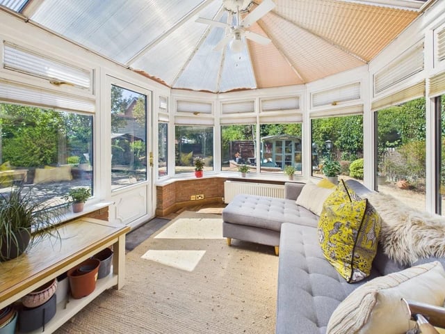 The conservatory boasts parquet flooring and views across the garden.