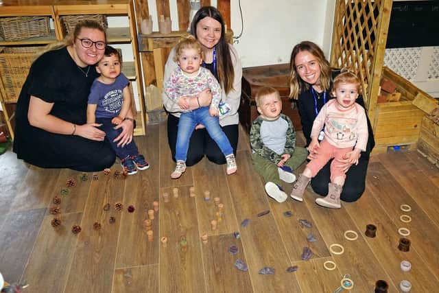Staff members Melissa Carlisle, Shellby Brown and Paula Black celebrate the 'good' raiting with nursery children.