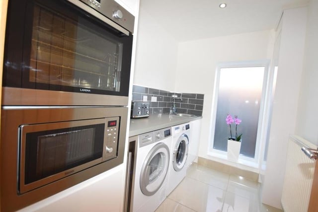 Even the utility room at the Ravenshead house oozes top-notch style. When you go in, the lights turn themselves on automatically, to reveal a third oven, base units, sink, inset microwave, plumbing for a washing machine and space for a dryer.