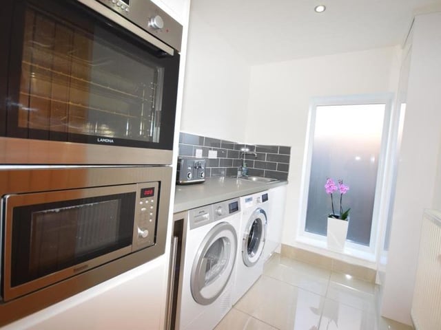 Even the utility room at the Ravenshead house oozes top-notch style. When you go in, the lights turn themselves on automatically, to reveal a third oven, base units, sink, inset microwave, plumbing for a washing machine and space for a dryer.