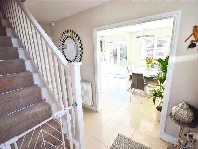A welcoming entrance with stairs off, tiled flooring and opening to the kitchen
