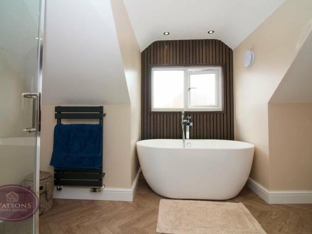 The family bathroom on the first floor has a contemporary look and feel to it, especially with its free-standing bath.