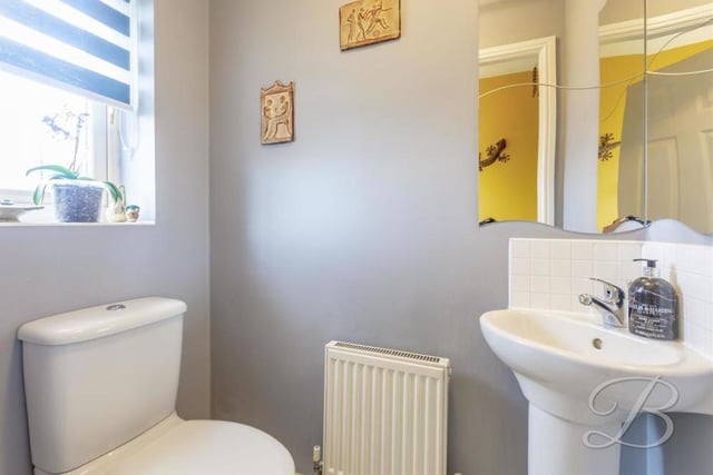 This is the downstairs toilet, off the entrance hallway. It comprises a low-flush WC, pedestal sink, central heating radiator and opaque window to the front of the house.