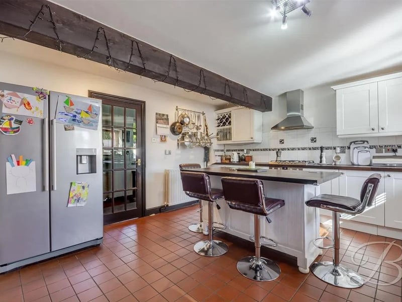 Integrated appliances in the kitchen includes an oven, gas hob, dishwasher, and an inset sink.