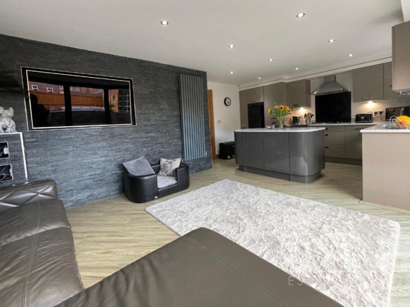 Moving into the house proper, here is a long-range view of the open-plan kitchen/diner, which also has a living area (foreground) attached.