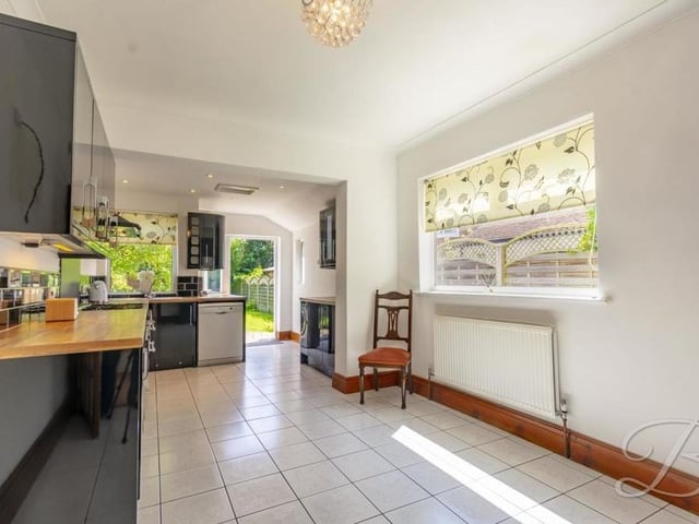 As you can see, the glossy kitchen has plenty of space to move around. It is the perfect spot to show off your culinary skills.
