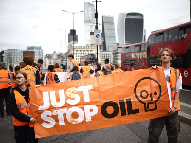 Just Stop Oil wants the government to end all new oil and gas exploration and has promised not to let up in its protests until it does so. (Photo by HENRY NICHOLLS / AFP) (Photo by HENRY NICHOLLS/AFP via Getty Images)