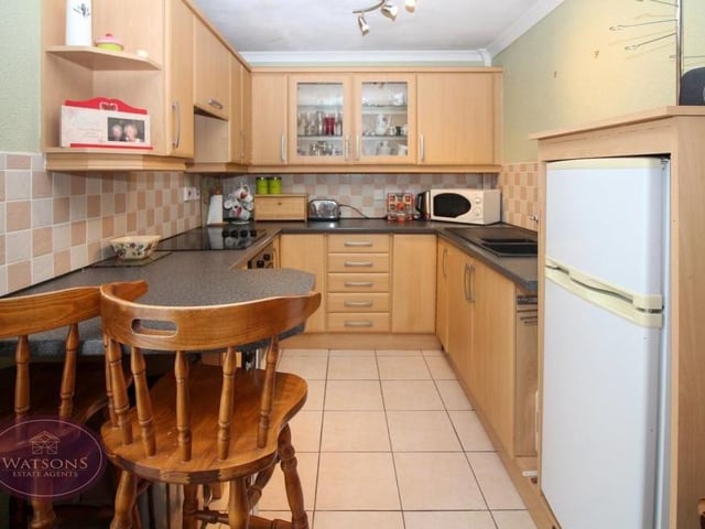 The kitchen in the annexe boasts a range of matching wall and base units, work surfaces incorporating a sink and drainer unit, induction hob with extractor over and also a breakfast bar. The floor is tiled.