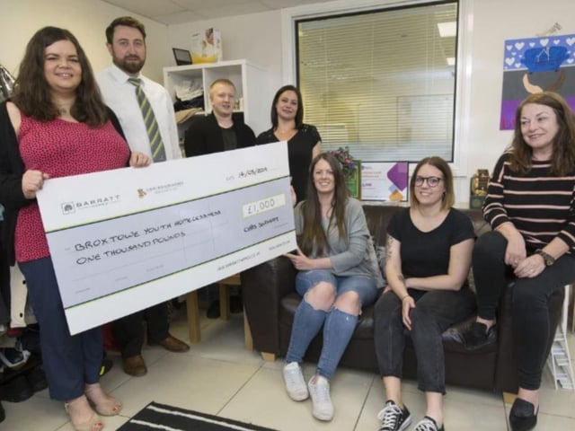 Abi Garvey and Matt Williams from Barratt & David Wilson North Midlands, handing over the cheque to The Broxtowe Youth Homelessness staff