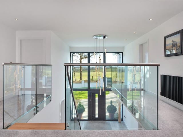 A wonderful galleried landing with superb easterly open countryside views to the front elevation.