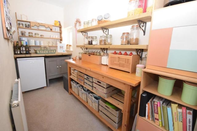 Just off the dining kitchen is this walk-in pantry. It offers additional storage space or could be put to a number uses, depending on your requirements. There are uPVC windows at the back, plus a radiator.
