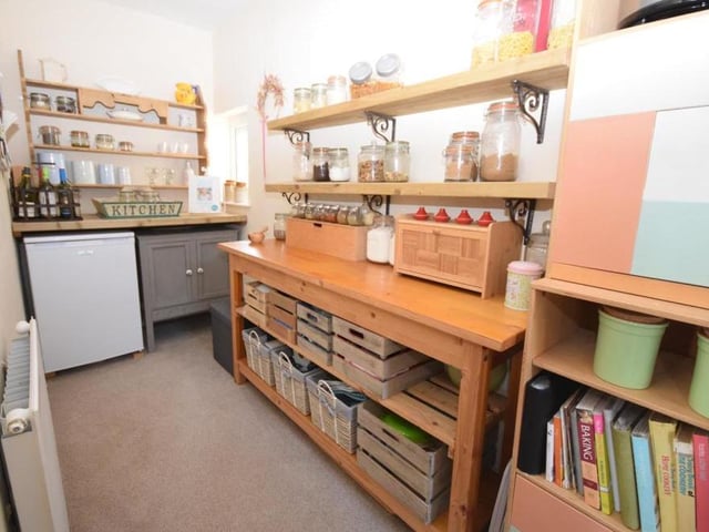 Just off the dining kitchen is this walk-in pantry. It offers additional storage space or could be put to a number uses, depending on your requirements. There are uPVC windows at the back, plus a radiator.