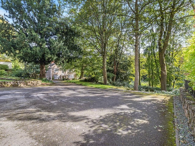 Leading up to the garage is a triple-width driveway that offers plenty of space for off-street parking.