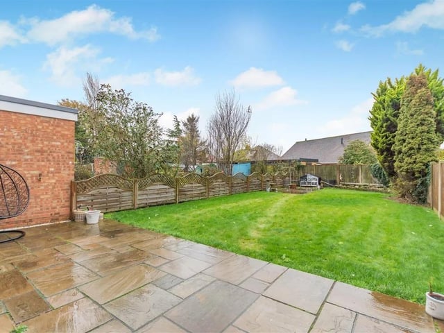 To the rear of the property, there is a good sized, south facing garden featuring a sandstone patio which extends across the full width of the property.