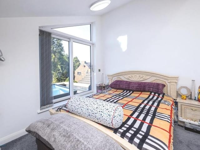 The master bedroom features sliding doors that open on to a rooftop balcony.