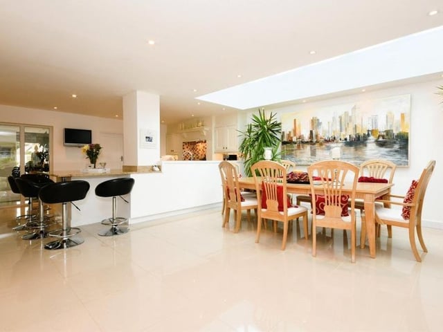 This photo leads us conveniently from the dining area towards the kitchen on the left.