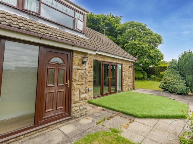 Rushing round to the front of the property again, and this snap shows the front door, the double doors that lead from the living room and also the bedroom built into the roof.