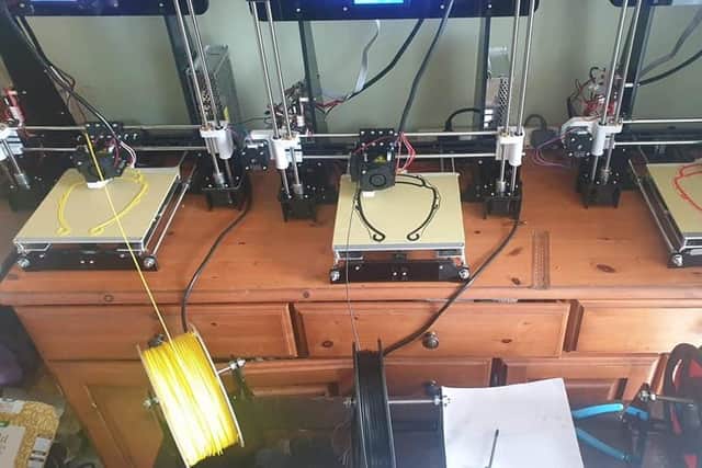 Three of the six 3D printers in action