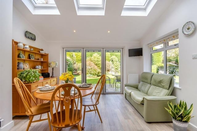 This is the terrific open-plan extension to the kitchen, which comprises a breakfast/dining area. It is cheerfully bright thanks to three large roof-windows and sliding bi-fold doors that open on to the private garden at the back of the property.