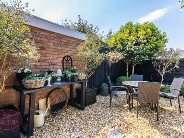 The back garden, which is enclosed by timber fencing, contains two patio areas, plus a covered pergola and gravel beds. There's certainly no shortage of space in which to relax or entertain family and friends.