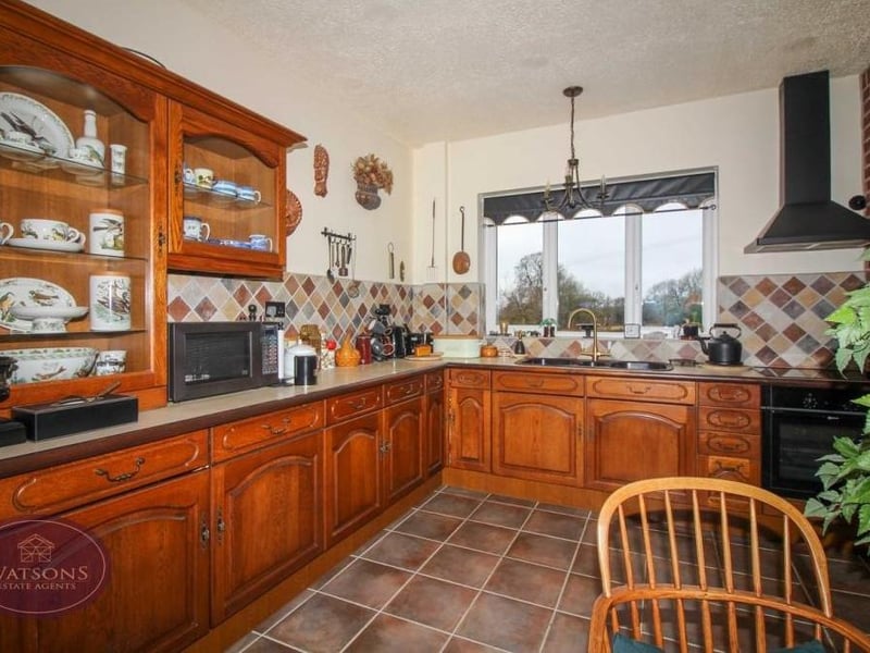 Integrated appliances in the breakfast kitchen include an electric oven and hob with extractor over, fridge and freezer. There are windows to the front and back of the house.